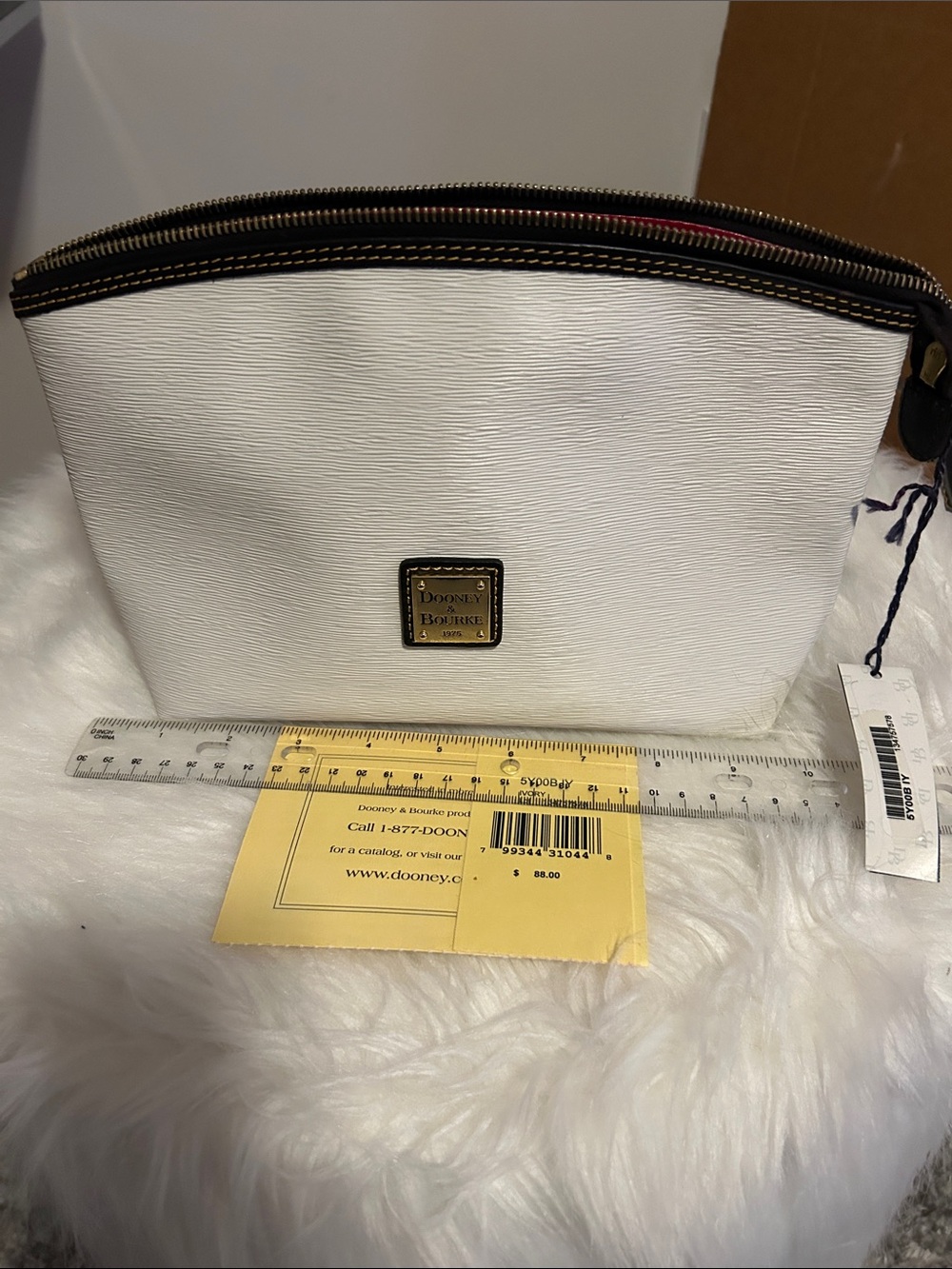 Dooney & Bourke White Textured Cosmetic Pouch with Gold Plaque NWT.